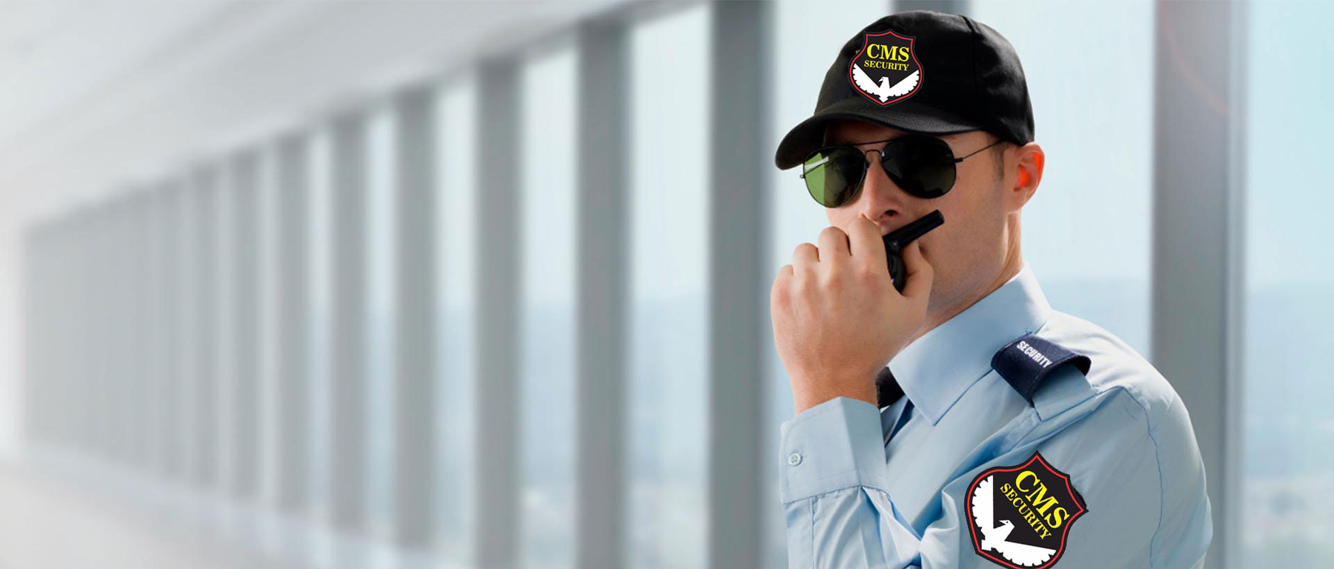 CMS Security guard in uniform using a radio – security guard services in Raipur, Chhattisgarh